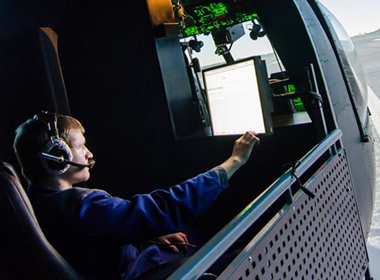 man in blue shirt doing a flight simulator